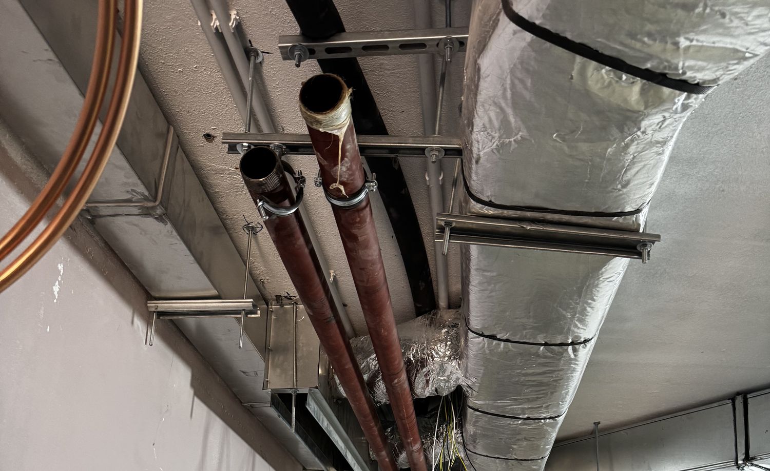 Installed ductwork and pipe hangers